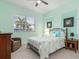 Comfortable bedroom features soothing light green walls, a cozy bed, and ample natural light from the window at 15618 Aqua Cir, Port Charlotte, FL 33981