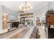 Inviting open-concept dining room with a rustic table, modern lighting, and bar area at 15618 Aqua Cir, Port Charlotte, FL 33981