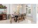 Bright dining room with a modern chandelier, wine bar, and large window for natural light at 15618 Aqua Cir, Port Charlotte, FL 33981