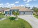 Beautiful single-story home featuring a tile roof, spacious driveway, and lush green lawn at 15618 Aqua Cir, Port Charlotte, FL 33981