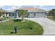 Charming single-story home with a tile roof, two-car garage, and meticulously landscaped front yard at 15618 Aqua Cir, Port Charlotte, FL 33981