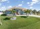 Inviting single-story home with a well-manicured lawn and decorative landscaping at 15618 Aqua Cir, Port Charlotte, FL 33981