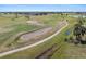 Aerial view of a lush green golf course on a sunny day at 15618 Aqua Cir, Port Charlotte, FL 33981