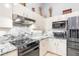 Modern kitchen features stainless steel appliances, granite countertops, and white cabinets at 15618 Aqua Cir, Port Charlotte, FL 33981