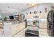 Contemporary kitchen with an island, granite countertops, and sleek black stainless steel appliances at 15618 Aqua Cir, Port Charlotte, FL 33981
