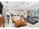 Open-concept living space with tile floors, fireplace, access to kitchen, and views of the outdoors at 15618 Aqua Cir, Port Charlotte, FL 33981