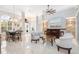 Spacious open-plan living area with a dining table, seating area, and bright natural light at 15618 Aqua Cir, Port Charlotte, FL 33981