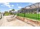 Relaxing patio with sun loungers and a view of the fenced backyard at 15618 Aqua Cir, Port Charlotte, FL 33981