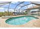 Inviting in-ground pool and spa within a screened enclosure for outdoor enjoyment at 15618 Aqua Cir, Port Charlotte, FL 33981