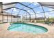 Screened in pool and hot tub area with chairs for lounging at 15618 Aqua Cir, Port Charlotte, FL 33981