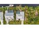 Aerial view of a home with a pool overlooking a canal, and tropical landscaping at 17342 Foremost Ln, Port Charlotte, FL 33948