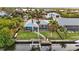 Aerial view of a home with a screened-in pool, private backyard, and boat dock on the canal at 17342 Foremost Ln, Port Charlotte, FL 33948