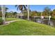 Expansive backyard with a waterfront view, featuring lush greenery and a private dock at 17342 Foremost Ln, Port Charlotte, FL 33948