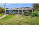 Well-manicured backyard with manicured landscaping and a view of the screened-in pool area at 17342 Foremost Ln, Port Charlotte, FL 33948