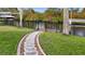Lush backyard with stone path leading to the waterfront dock, ideal for enjoying nature at 17342 Foremost Ln, Port Charlotte, FL 33948