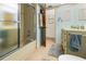 Bathroom featuring neutral tile, a shower with glass door, and a vanity with storage at 17342 Foremost Ln, Port Charlotte, FL 33948