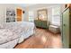 Bright bedroom with hardwood floors, a large mirror, and ample natural light from the windows at 17342 Foremost Ln, Port Charlotte, FL 33948