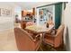 Breakfast nook with peach upholstered chairs around a table with a kitchen view at 17342 Foremost Ln, Port Charlotte, FL 33948