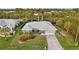 Beautiful front exterior with lush landscaping and a well-maintained lawn at 17342 Foremost Ln, Port Charlotte, FL 33948