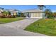 A lovely home with a well-manicured lawn and wide driveway at 17342 Foremost Ln, Port Charlotte, FL 33948