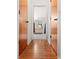 Hallway leading to the primary bathroom showcases hardwood floors and wood trim at 17342 Foremost Ln, Port Charlotte, FL 33948