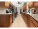 A galley kitchen showcases wood cabinets, granite countertops, tile backsplash, and stainless steel appliances at 17342 Foremost Ln, Port Charlotte, FL 33948
