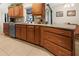 Kitchen with wood cabinets, granite countertops, stainless steel dishwasher, and tiled floors at 17342 Foremost Ln, Port Charlotte, FL 33948