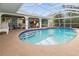 Enclosed pool area featuring a sparkling blue pool, ample seating, and a relaxing atmosphere at 17342 Foremost Ln, Port Charlotte, FL 33948