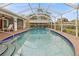 Screened-in pool area offers a serene escape with lush landscaping and comfortable seating at 17342 Foremost Ln, Port Charlotte, FL 33948