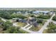 A beautiful aerial view of a quiet neighborhood with mature trees and a view of the water at 18379 Edgewater Dr, Port Charlotte, FL 33948