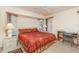 Bedroom featuring a ceiling fan, neutral walls, a side table, and a writing desk at 18379 Edgewater Dr, Port Charlotte, FL 33948