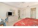 Bright bedroom featuring a ceiling fan, neutral walls, and access to additional rooms at 18379 Edgewater Dr, Port Charlotte, FL 33948
