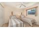 Bright bedroom boasts two twin beds, a window, neutral walls, and comfortable carpet at 18379 Edgewater Dr, Port Charlotte, FL 33948