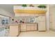 Open kitchen with matching appliances, bar top, and passthrough to living room; refrigerator included at 18379 Edgewater Dr, Port Charlotte, FL 33948
