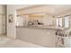 Well-lit kitchen featuring a functional layout with bar seating and a pass-through to living room at 18379 Edgewater Dr, Port Charlotte, FL 33948