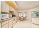 Bright kitchen with matching appliances and adjacent dining area with bay windows and lanai access at 18379 Edgewater Dr, Port Charlotte, FL 33948