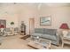 Spacious living room with plush seating, neutral carpet, a ceiling fan, and bright natural lighting at 18379 Edgewater Dr, Port Charlotte, FL 33948