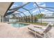 Enclosed pool area with a sun-soaked patio and chaise lounges ideal for relaxation at 18379 Edgewater Dr, Port Charlotte, FL 33948