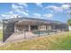 Back view of screened in pool with covered patio and seating, great for entertaining at 18379 Edgewater Dr, Port Charlotte, FL 33948