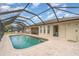 Inviting pool area with a screened enclosure, a covered patio, and ample space for lounging at 18379 Edgewater Dr, Port Charlotte, FL 33948