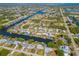 Aerial view of waterfront community with canal access and lush landscaping, showing proximity to the ocean at 18446 Burkholder Cir, Port Charlotte, FL 33948
