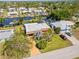 Aerial view of property, showcasing the landscaped yard and waterside community at 18446 Burkholder Cir, Port Charlotte, FL 33948