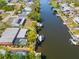 Stunning aerial view of waterfront property with pool and dock, ideal for boating enthusiasts at 18446 Burkholder Cir, Port Charlotte, FL 33948