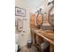 Bathroom features double sinks with decorative mirrors, fixtures and lighting at 18446 Burkholder Cir, Port Charlotte, FL 33948