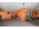 Spacious carport is orange with chairs, furniture, and plenty of storage at 18446 Burkholder Cir, Port Charlotte, FL 33948