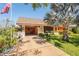 Charming single-story home featuring unique stonework, a barrel tile roof, and a well-maintained front yard at 18446 Burkholder Cir, Port Charlotte, FL 33948