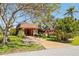 Charming home with a well manicured yard, mature trees, and long driveway at 18446 Burkholder Cir, Port Charlotte, FL 33948