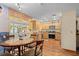 Open kitchen with wooden cabinets, granite countertops, stainless steel appliances, and wood-look flooring at 18446 Burkholder Cir, Port Charlotte, FL 33948