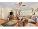 Inviting living room with a comfortable sectional sofa, rustic decor, and lots of natural light at 18446 Burkholder Cir, Port Charlotte, FL 33948