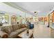 Spacious living room flowing into dining area, featuring tile floors and lots of natural light at 18446 Burkholder Cir, Port Charlotte, FL 33948